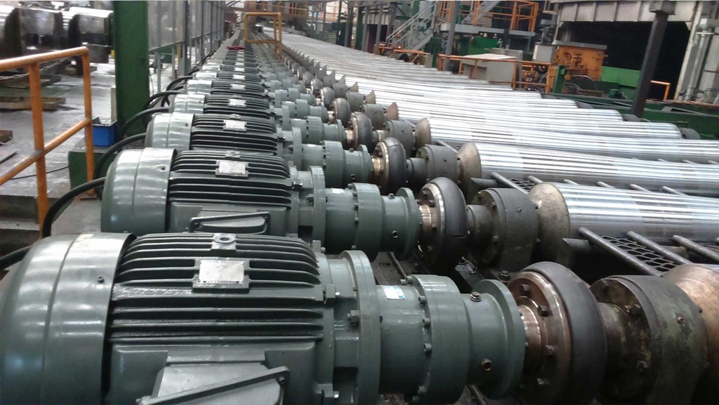 Conveyor line closeup with rollers that are controlled by planetary speed reducers