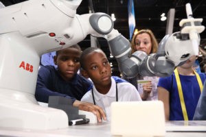 Children viewing transcyko robot arm reducer